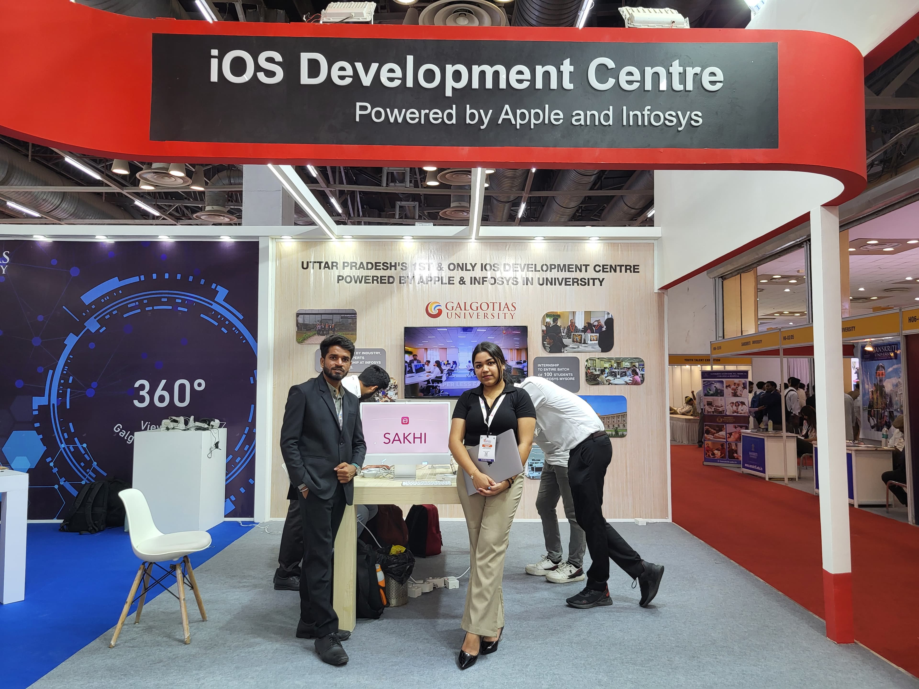 Team Sakhi at the Apple and Infosys-powered iOS Development Centre exhibition booth, Galgotias University, with the Sakhi app open on screen